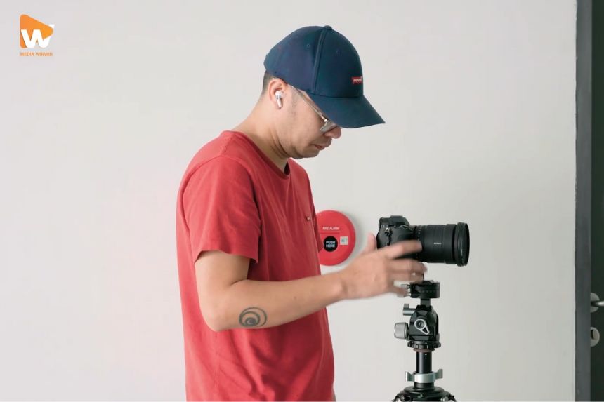  Nhiếp ảnh gia đang set up ánh sáng để chụp ảnh phòng khách sạn đẹp.